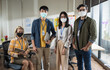 © saksit - Portrait of Asian creative business team wears face mask. Hipster Creative Startup Young business people in modern office.