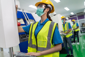 Employees working in the factory with machines