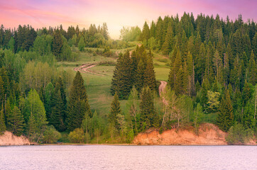 Canvas Print - The hilly riverbank goes up the road to the purple sunset sunrise.