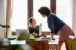 © ALTO IMAGES/Stocksy - Businesswoman Talking With Colleague In Creative Office