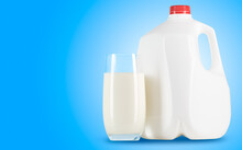 Milk. Glass Of Milk And One Gallon Of Whole Milk On Blue Background. Organic Milk Product. White Plastic Bottle One Gallon Or 3.78 Liter.