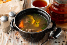 Spicy And Warm Autumn Soup On Meat Broth, Served In Rustic Pot On A Wooden Table