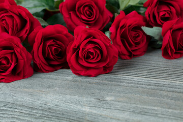 Sticker - Close up of a red cloth rose on aged wood