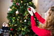 © Jovana Rikalo/Stocksy - Happy sisters decorating the Christmas tree