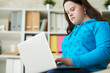 © Clique Images/Stocksy - Differently-abled teenager using laptop