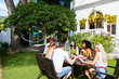 © BONNINSTUDIO/Stocksy - Group of young friends gathering in a summer lunch.