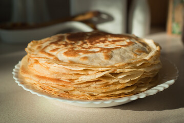 homemade pancakes. in the photo, pancakes cooked at home, illuminated by sunlight in the kitchen, close-up