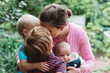© Chelsea Victoria/Stocksy - A mother and her children posing for portraits