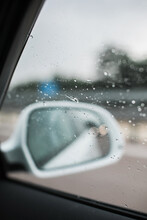 Rear Mirror Of A White Car On A Rainy Day