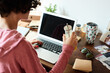 © Guille Faingold/Stocksy - Woman having drink at laptop