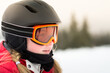 © blurMEDIA/Stocksy - Girl in goggles and snow helmet excited skiing