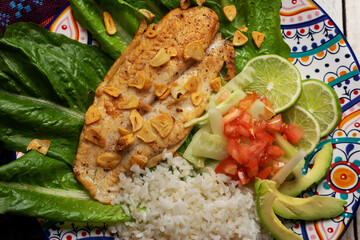 Wall Mural - Fish steak with garlic, salad and rice on white background