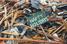 Happy Holidays Sign In Front Of Remains Of Destroyed Home