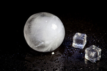 Wall Mural - ice ball reflection on black background.