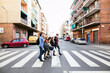 © BONNINSTUDIO/Stocksy - Side view of group of teen friends crossing the street.