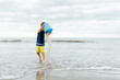 © LÔøΩÔøΩa Jones/Stocksy - boy dumping water out of bucket at the seaside