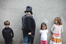 Young Children Waiting To Go Trick Or Treating At Halloween