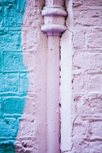 Blue And Pink Painted Wall And Drain Pipe.