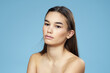 © SHOTPRIME STUDIO - brunette with bare shoulders cosmetics close-up skin care blue background