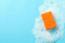 Orange Sponge And Foam On Blue Background