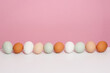 Organic eggs as easter eggs in front of a pink background 
