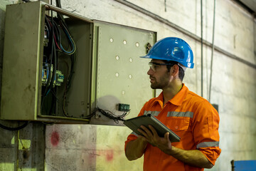 Fototapete - Engineer or factory worker using digital tablet checking inspecting metal component at machine in factory.