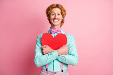 Sticker - Photo of young happy positive funky funny smiling cheerful gentleman hug big red heart isolated on pink color background