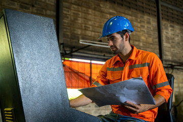 Aufkleber - Engineer in factory watching blueprint for the working process.