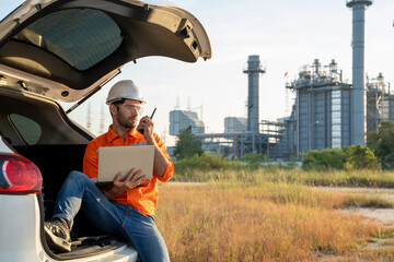Aufkleber - Refinery industry engineer sitting on car and working with computer laptop against oil refinery background.