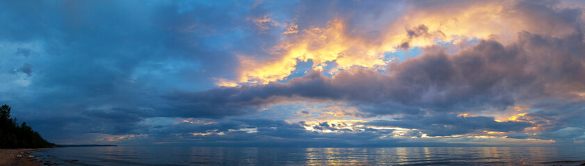 Wall Mural - Beautiful landscape with colorful clouds over Baikal Lake at summer evening. Panoramic view of Small Sea from coast of Olkhon Island at sunset. Natural background. Weather, meteorology, environment