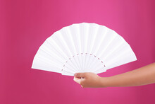 Woman Holding White Hand Fan On Pink Background, Closeup