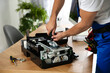 © New Africa - Repairman with screwdriver fixing modern printer indoors, closeup