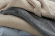 © New Africa - Stack of cashmere clothes as background, closeup