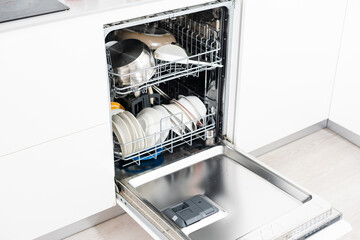 Picture of an opened dishwasher in the kitchen