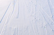 ski trail in the white and blue snow on mountain surface, snowboard track pattern, winter sports activity snowу way, cold day beautiful lines on snow texture outdoor