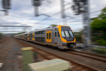 Commuter Train fast moving through a Station in Sydney NSW Australia