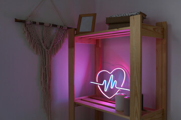 Neon sign pink and blue heart in the decor of the home. Trendy style. Neon sign. Custom neon. Home decor. Valentine day. Modern trendy background.