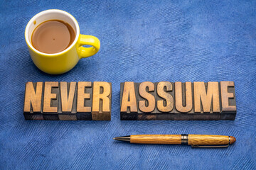 Sticker - never assume advice or reminder - word abstract in vintage letterpress wood type with a coffee, open mind and stereotype concept