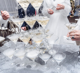 Pyramid of glasses with champagne close up.