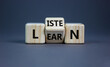 © Dzmitry - Listen and learn symbol. Turned a wooden cube and changed the word 'listen' to 'learn'. Beautiful grey background, copy space. Business, education and listen and learn concept.