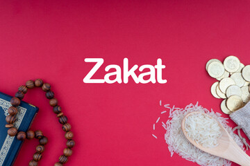 Wall Mural - ZAKAT words with Holy Quran, Coins, Rosary and Rice. Zakat concept. Zakat is a form of alm-giving as a religious obligation