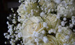White roses and gypsophila on a black background. Beautiful floral arrangement. 