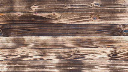 Aufkleber - Wooden floor with traces of being burnt makes a black abstract background and texture.