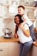© iordani - young pretty african american mother with little cute son on kitchen in morning preparing breakfast, lifestyle people concept