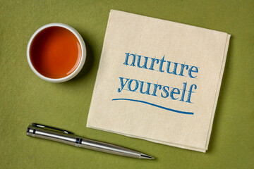 Wall Mural - nurture yourself - inspirational handwriting on a napkin with a cup of tea, self care concept