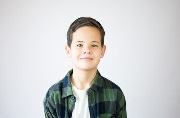 Portrait of happy young boy confident boy standing isolated on blue