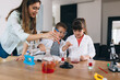 © cherryandbees - mother with her kids do chemical experiments in their home