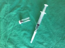 Close-up Of Syringe On Green Fabric