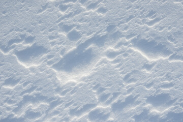 Fresh clean white snow background texture. Winter background with frozen snowflakes and snow mounds. Snow lumps. Seasonal landscape details. Cold weather.