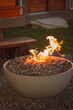 Outdoor modern firepit with burning flames.